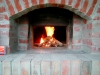 The small warming fire. It is gradually moved to the rear of the oven.